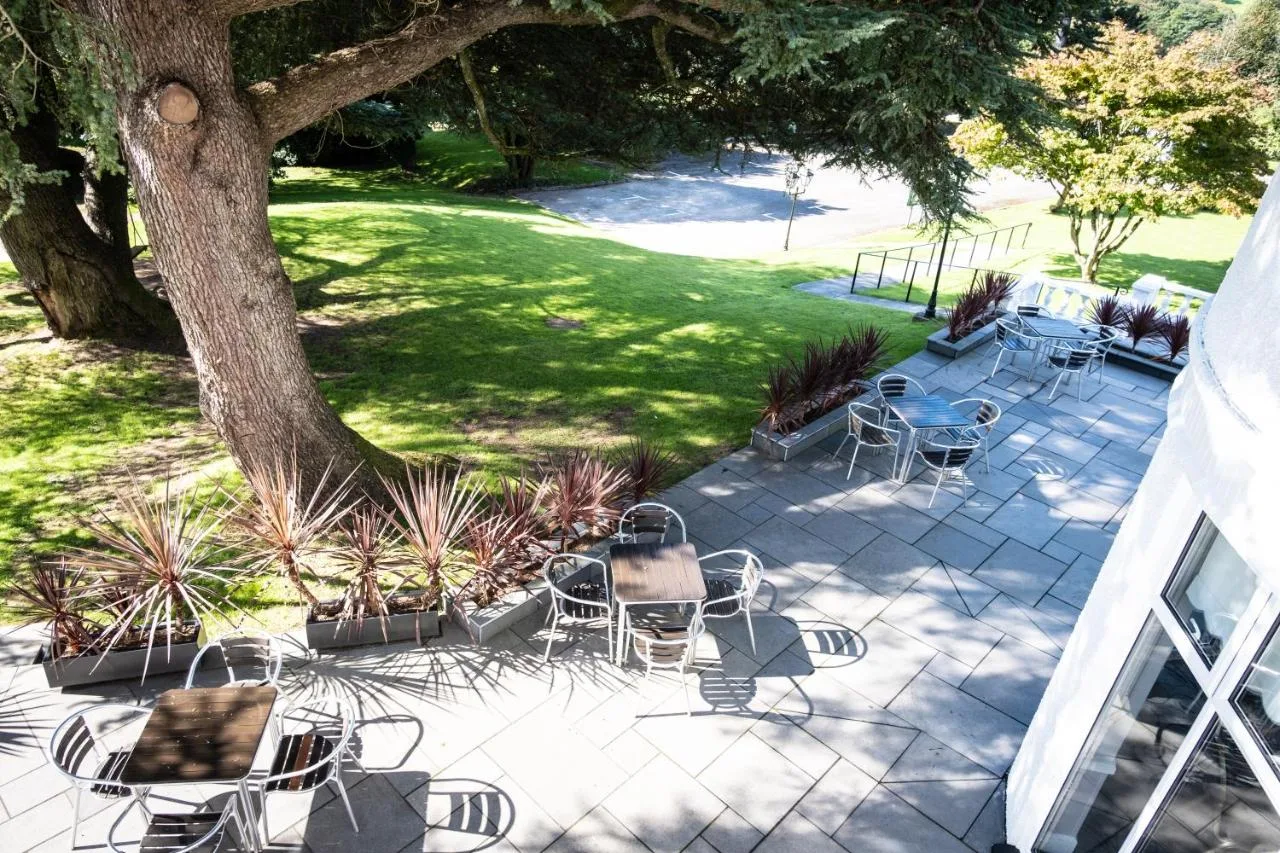 a group of chairs and tables on a patio at Manor Parc Hotel in Cardiff